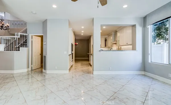 a kitchen with granite countertop white cabinets and white appliances