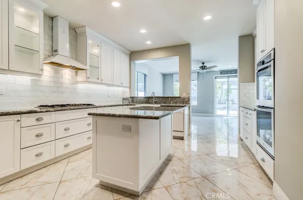 a kitchen with granite countertop a stove and a sink