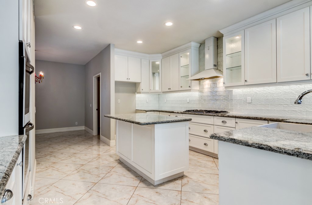 8 Zinnia Irvine, CA 92618 - Photo 25 of 63 a kitchen with stainless steel appliances granite countertop a sink and a refrigerator