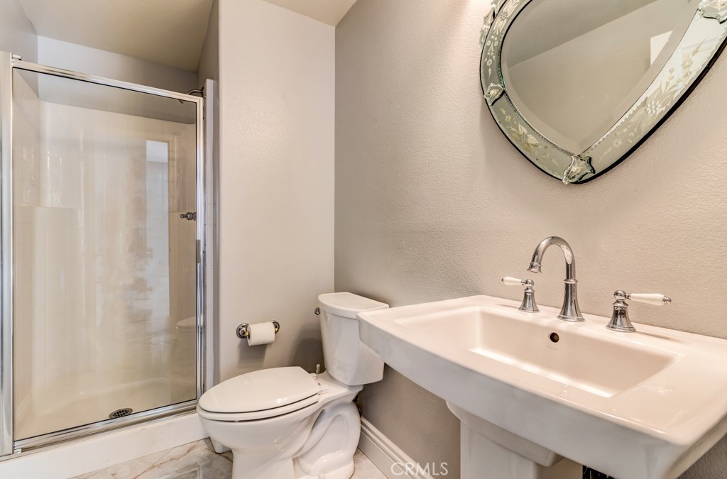 8 Zinnia Irvine, CA 92618 - Photo 27 of 63 a bathroom with a sink toilet and shower
