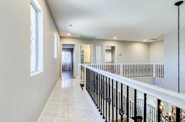an empty room with wooden floor and a bathroom