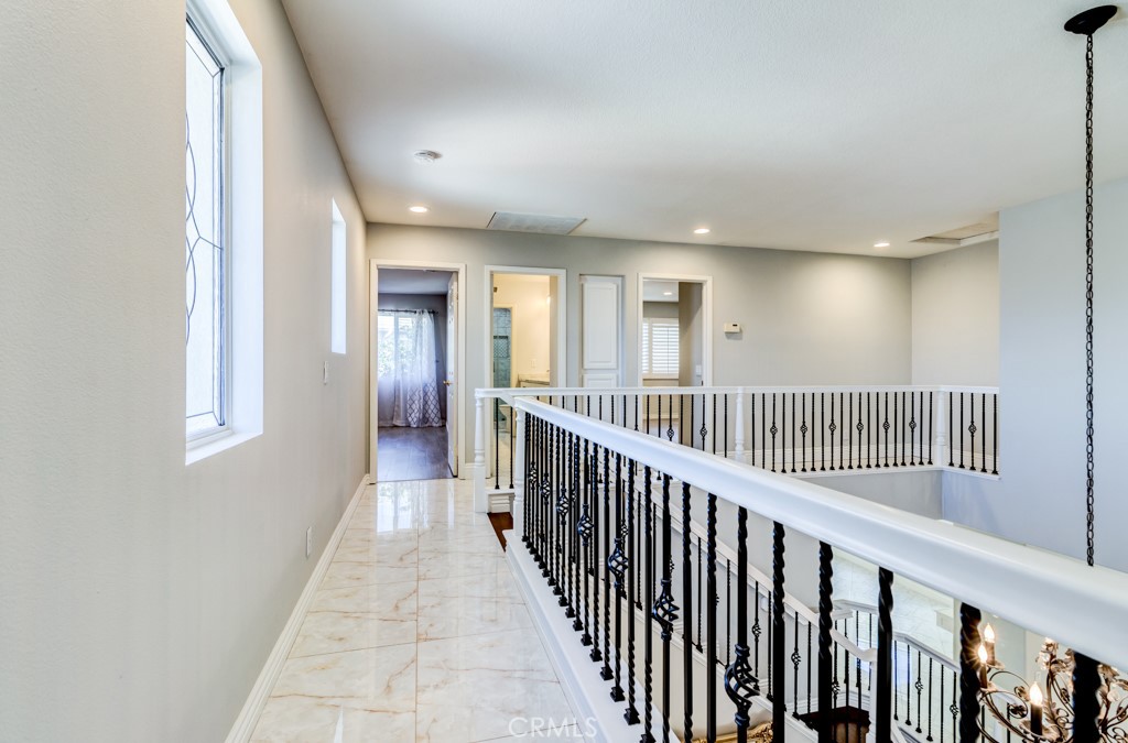 8 Zinnia Irvine, CA 92618 - Photo 32 of 63 a view of a hallway with wooden floor and windows