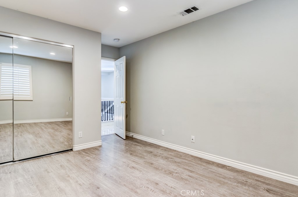 8 Zinnia Irvine, CA 92618 - Photo 42 of 63 an empty room with wooden floor and windows