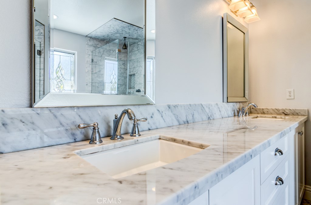 8 Zinnia Irvine, CA 92618 - Photo 44 of 63 a bathroom with a granite countertop sink and a mirror