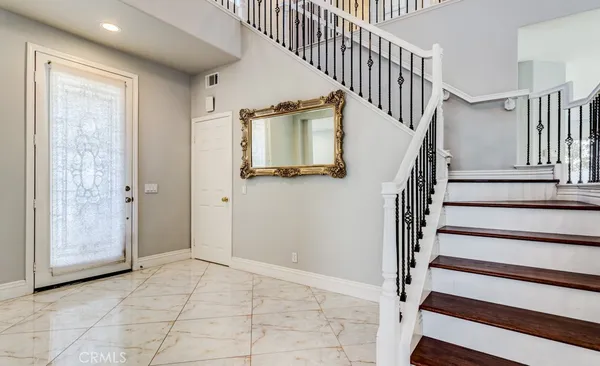 a view of entryway and hall with wooden floor