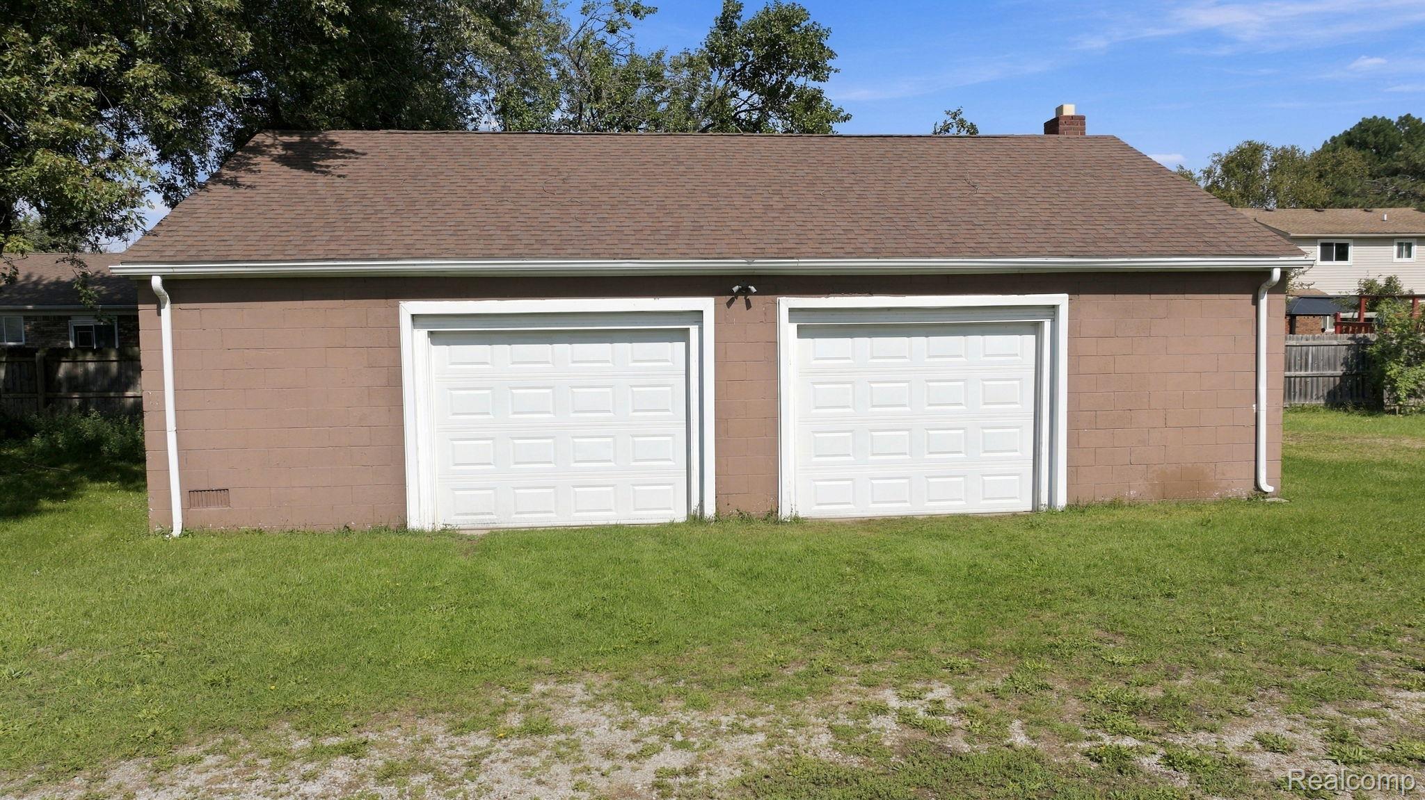 5353 18 Mile Road Sterling Heights, MI 48314 - Photo 40 of 53 Detached two-car garage with painted block construction and a shingle roof