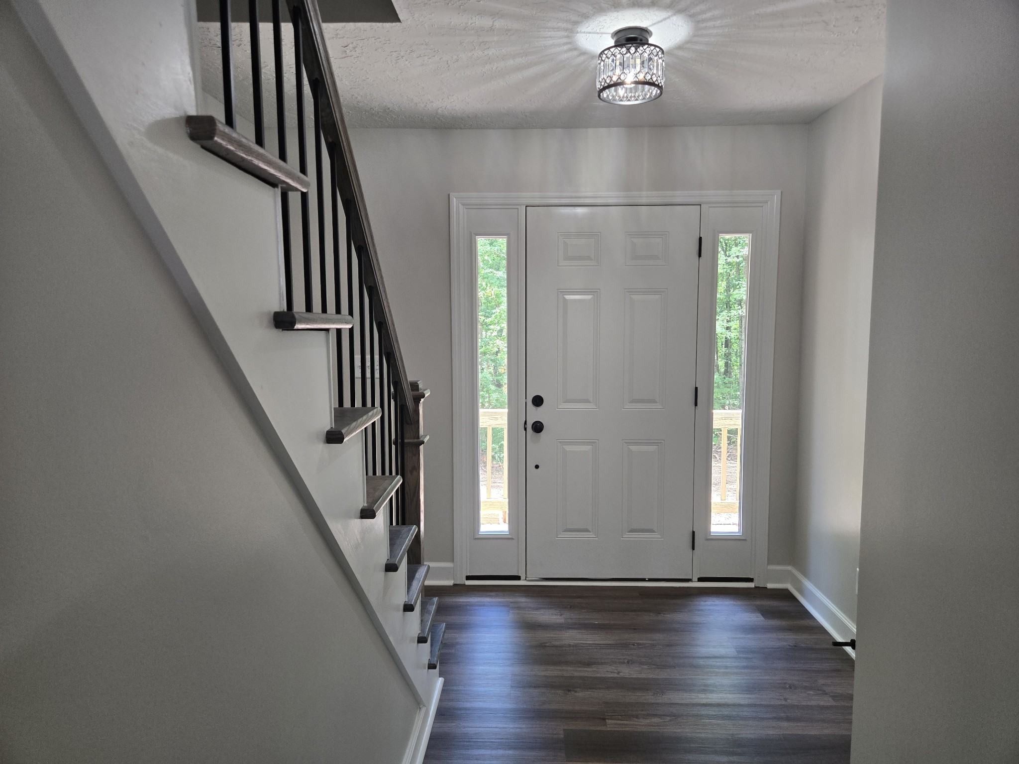 7 Bush Court Waverly, TN 37185 - Photo 13 of 48 wooden floor in an empty room with a chandelier