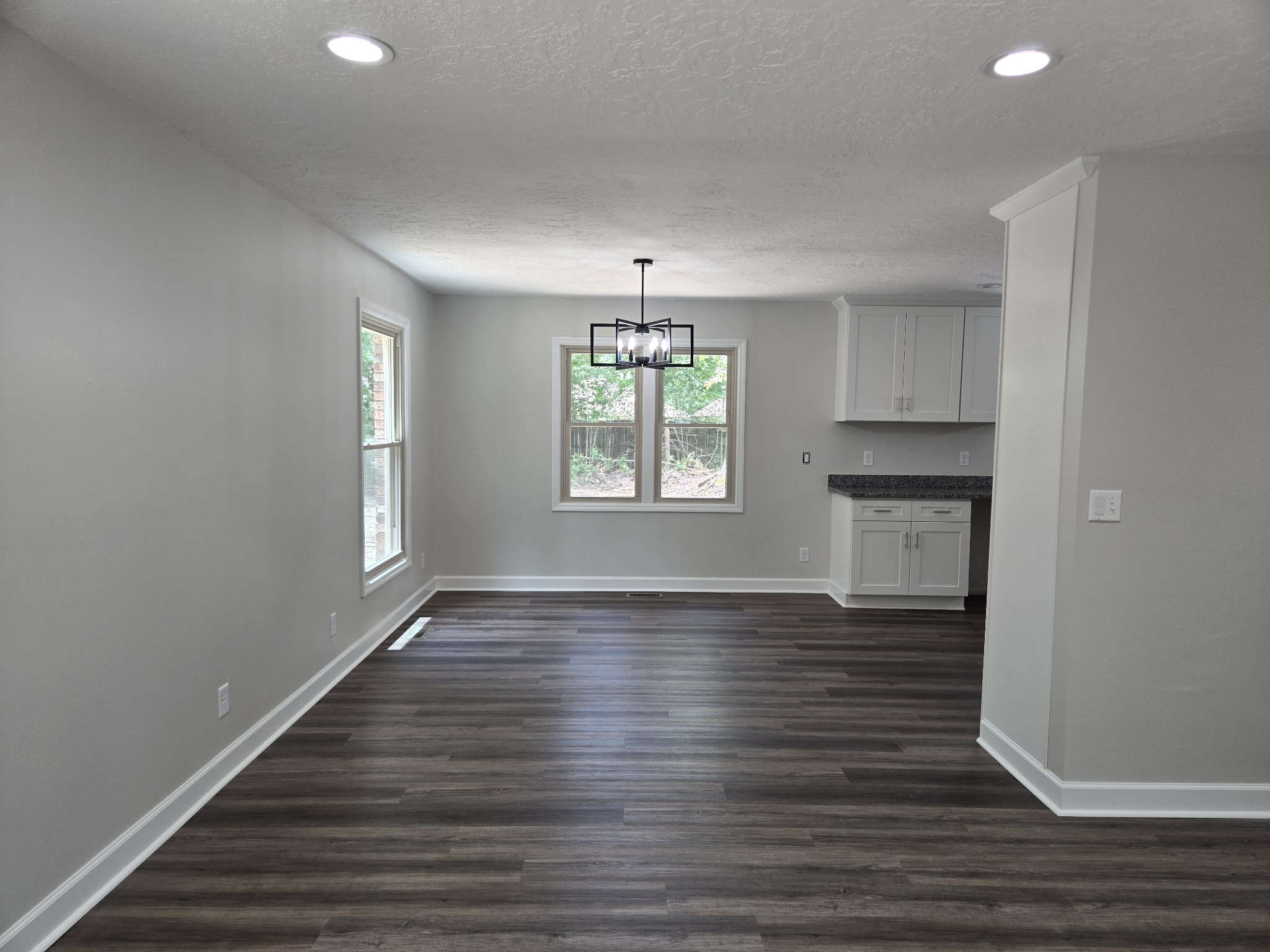 7 Bush Court Waverly, TN 37185 - Photo 16 of 48 an empty room with wooden floor chandelier and windows