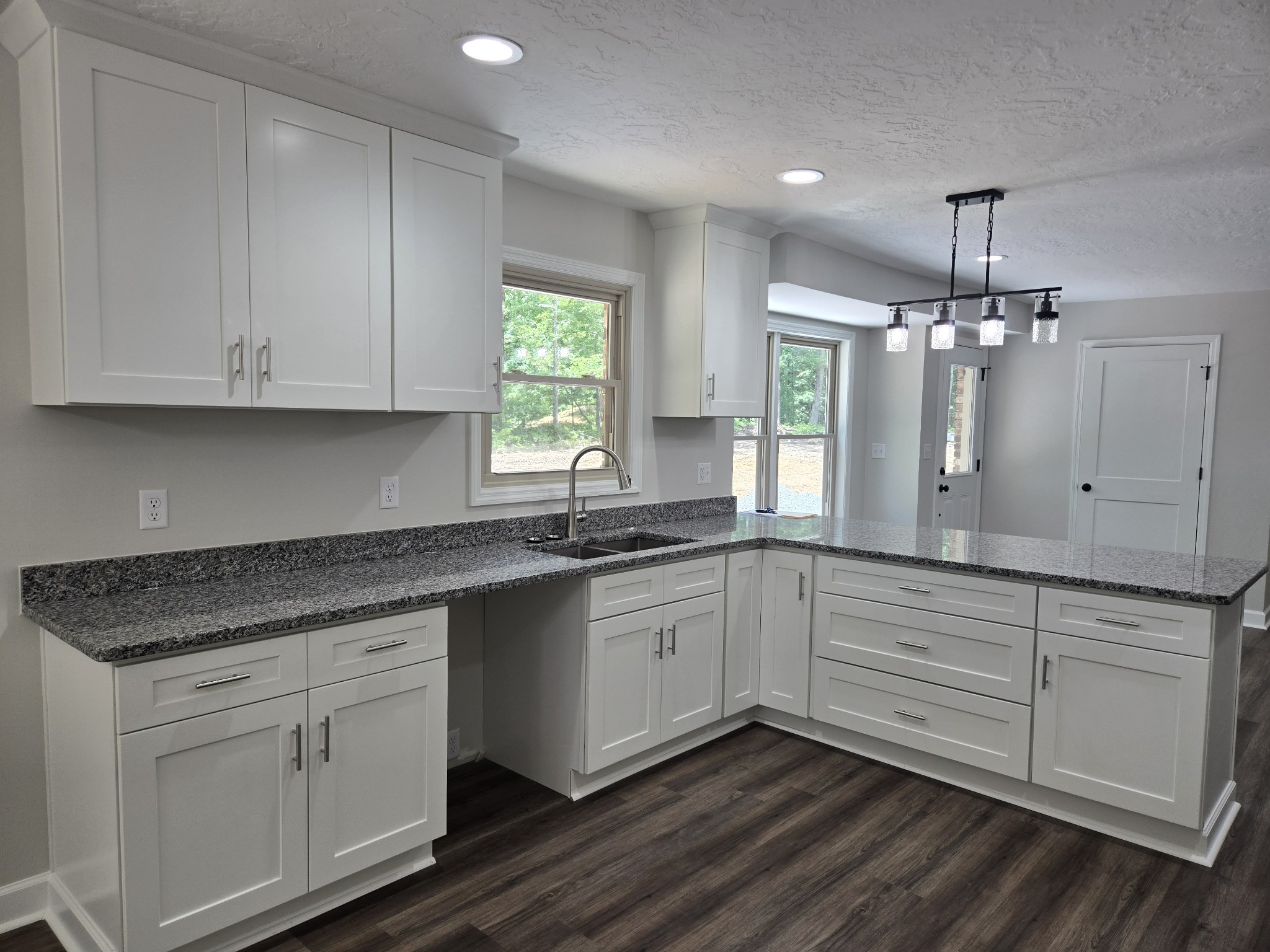 7 Bush Court Waverly, TN 37185 - Photo 19 of 48 a kitchen with granite countertop white cabinets and white appliances