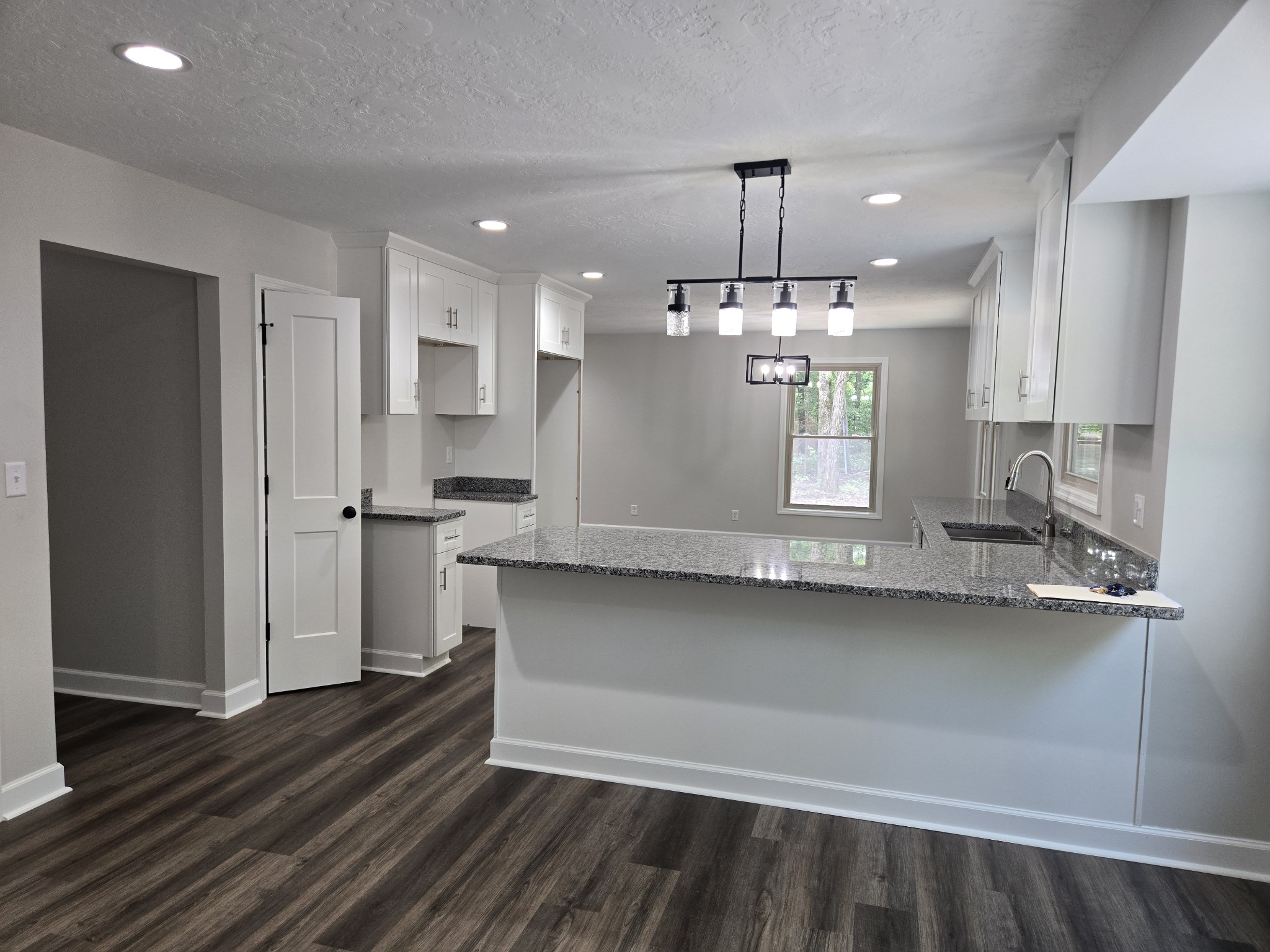 7 Bush Court Waverly, TN 37185 - Photo 20 of 48 a large kitchen with granite countertop a stove a sink dishwasher and a refrigerator with wooden floor