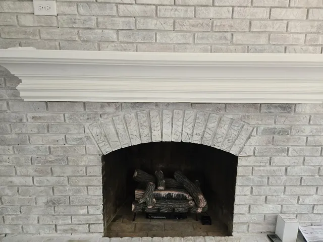 a view of a hallway with wooden floor and a bathroom