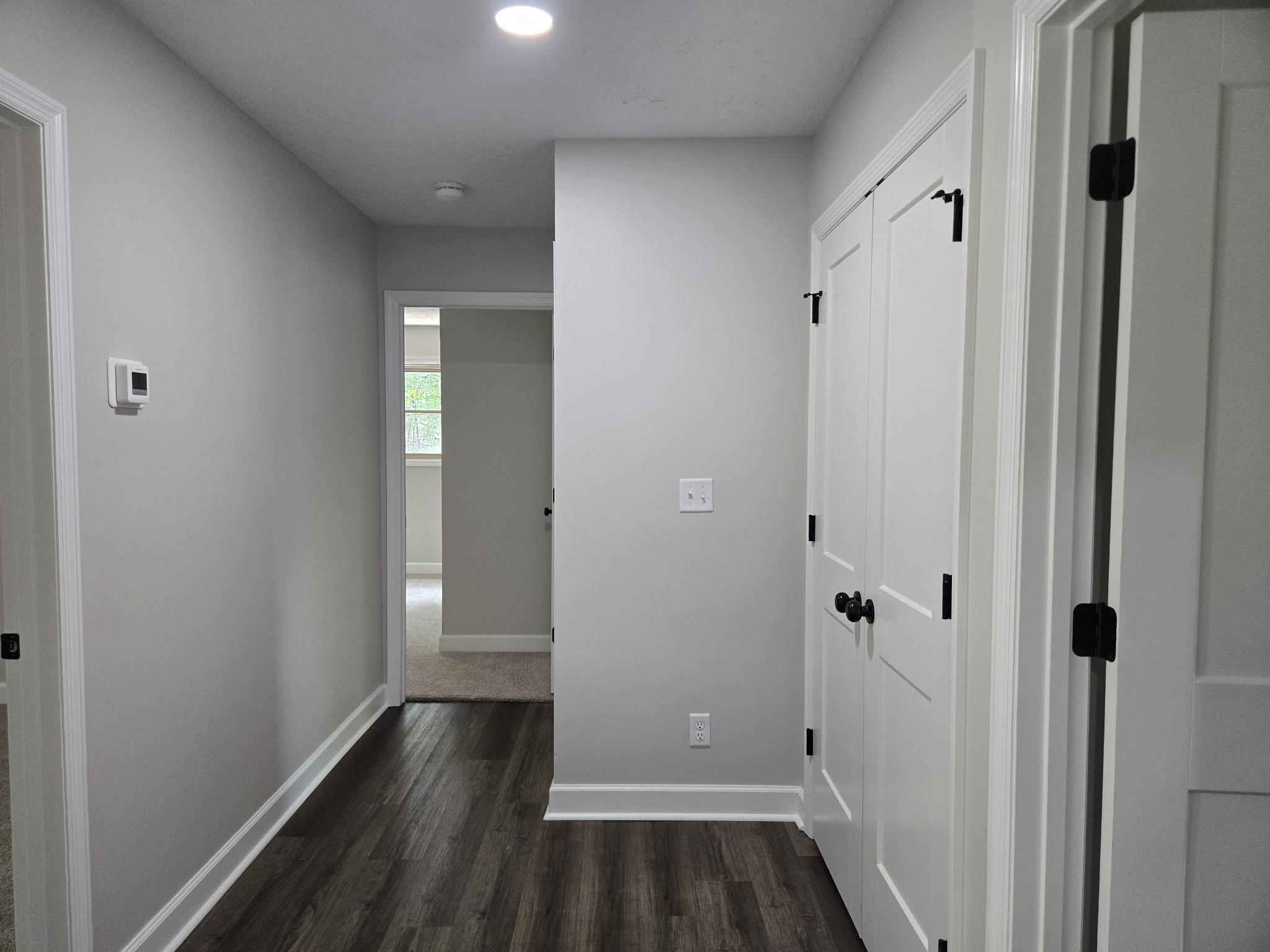 7 Bush Court Waverly, TN 37185 - Photo 42 of 48 a view of a hallway with wooden floor and a bathroom