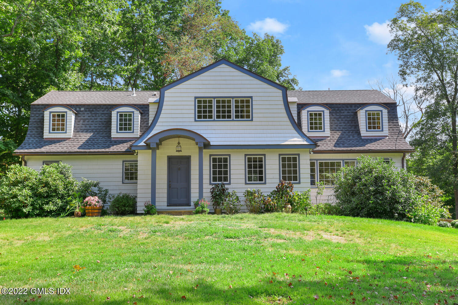 a front view of a house with garden
