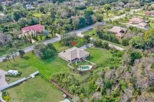 an aerial view of a houses with outdoor space and street view