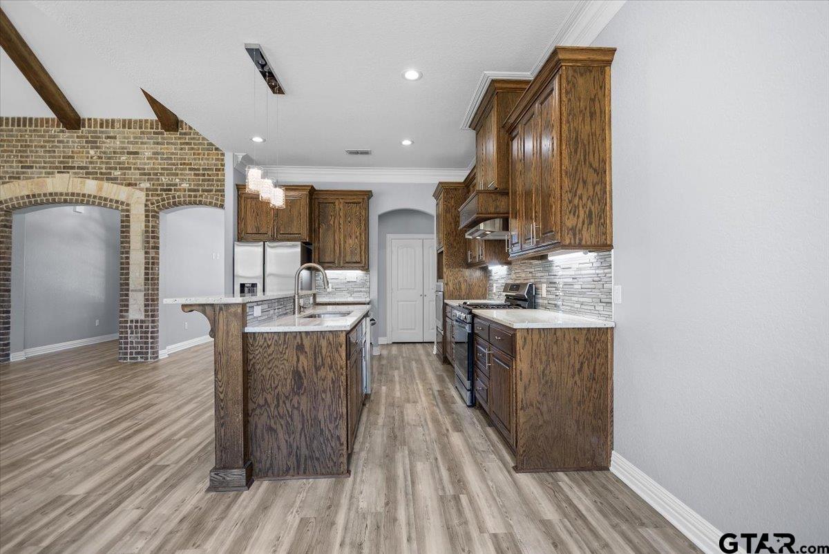 9629 Matise Street Tyler, TX 75706 - Photo 11 of 48 a kitchen with stainless steel appliances granite countertop a sink refrigerator and cabinets