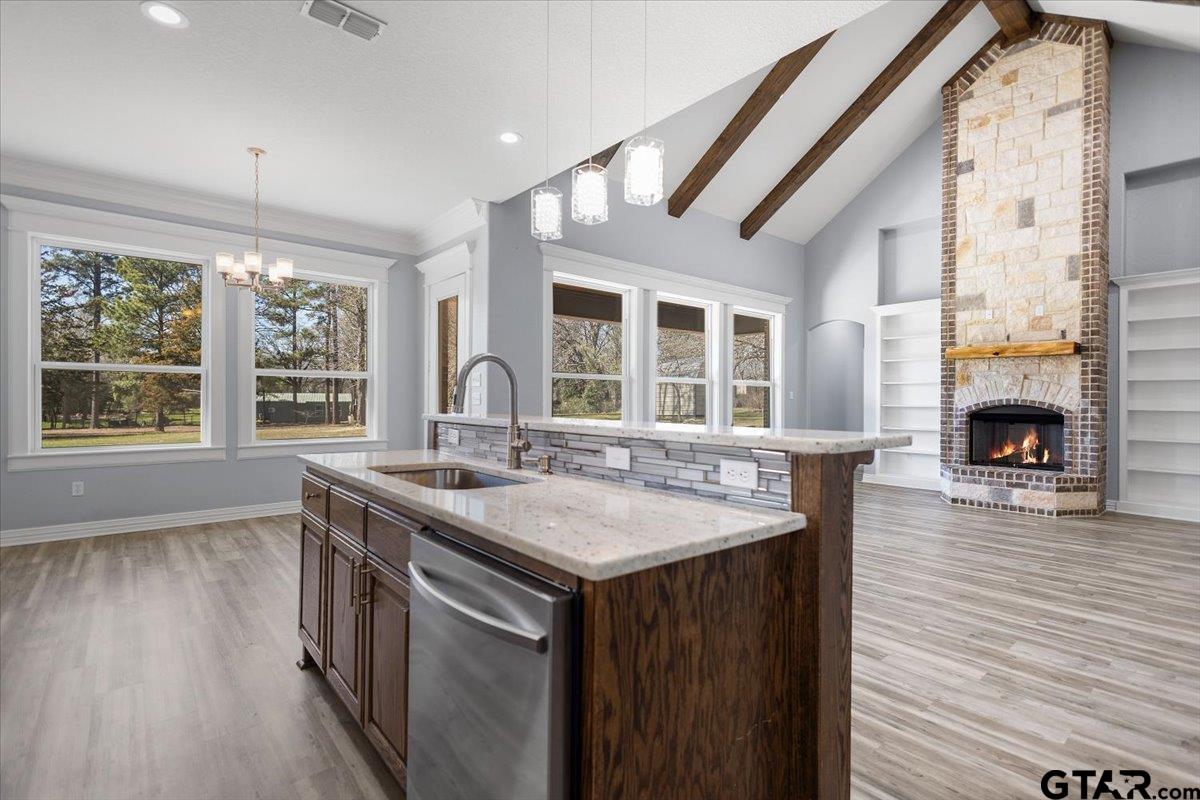 9629 Matise Street Tyler, TX 75706 - Photo 13 of 48 a kitchen with center island wooden floor and a large window
