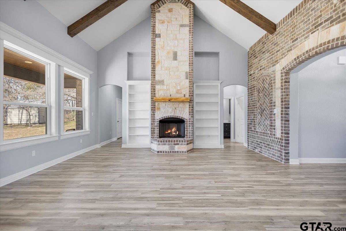 9629 Matise Street Tyler, TX 75706 - Photo 14 of 48 a view of empty room with fireplace and wooden floor