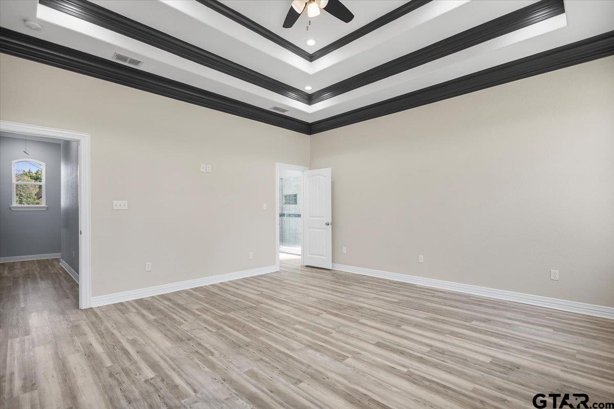 9629 Matise Street Tyler, TX 75706 - Photo 20 of 48 an empty room with wooden floor and ceiling fan