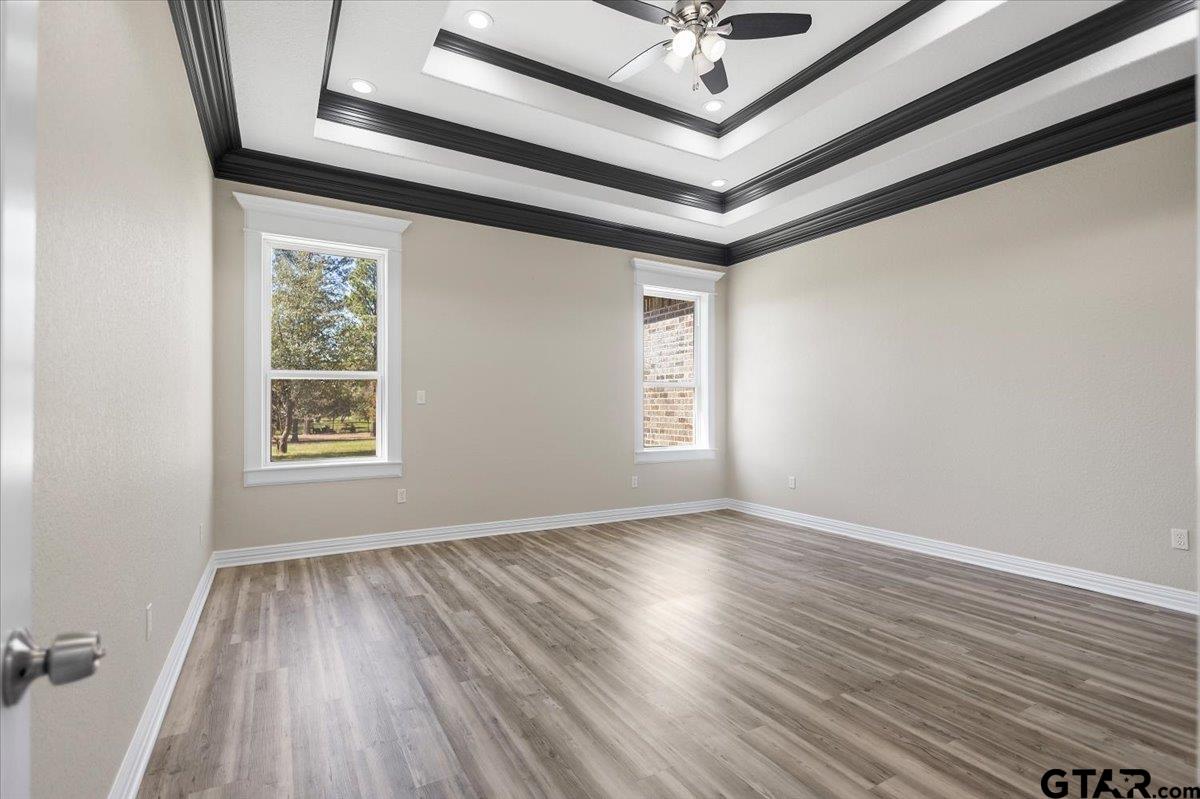 9629 Matise Street Tyler, TX 75706 - Photo 22 of 48 a view of an empty room with wooden floor and a window