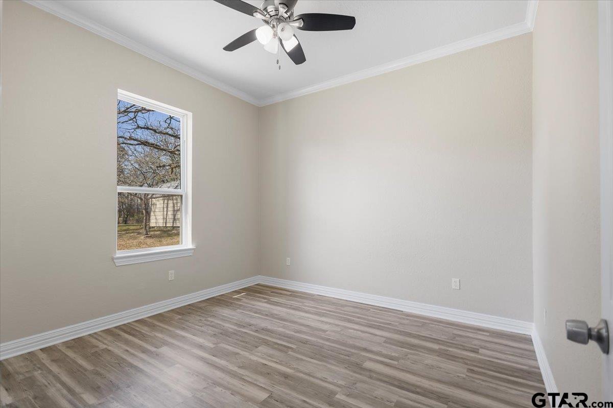 9629 Matise Street Tyler, TX 75706 - Photo 32 of 48 a view of an empty room with wooden floor and a window