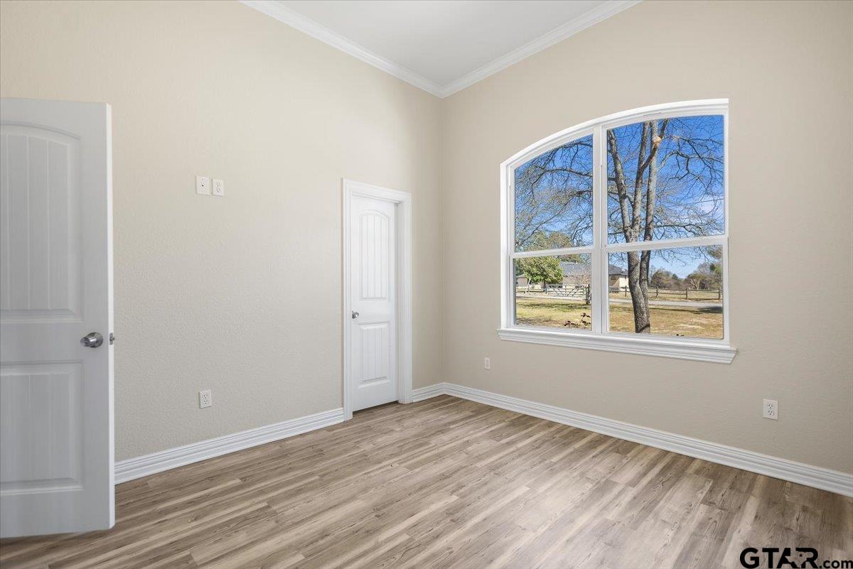 9629 Matise Street Tyler, TX 75706 - Photo 41 of 48 a view of an empty room with wooden floor and a window