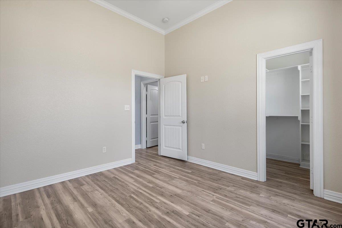 9629 Matise Street Tyler, TX 75706 - Photo 44 of 48 a view of an empty room with wooden floor & closet