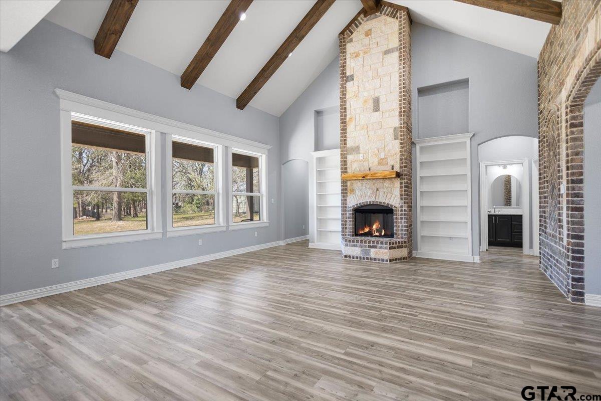 9629 Matise Street Tyler, TX 75706 - Photo 7 of 48 an empty room with windows fireplace and wooden floor