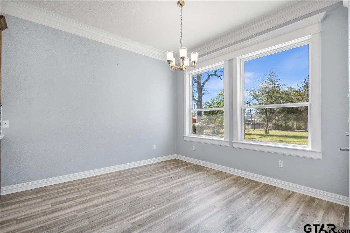 9629 Matise Street Tyler, TX 75706 - Photo 9 of 48 wooden floor in an empty room with a window