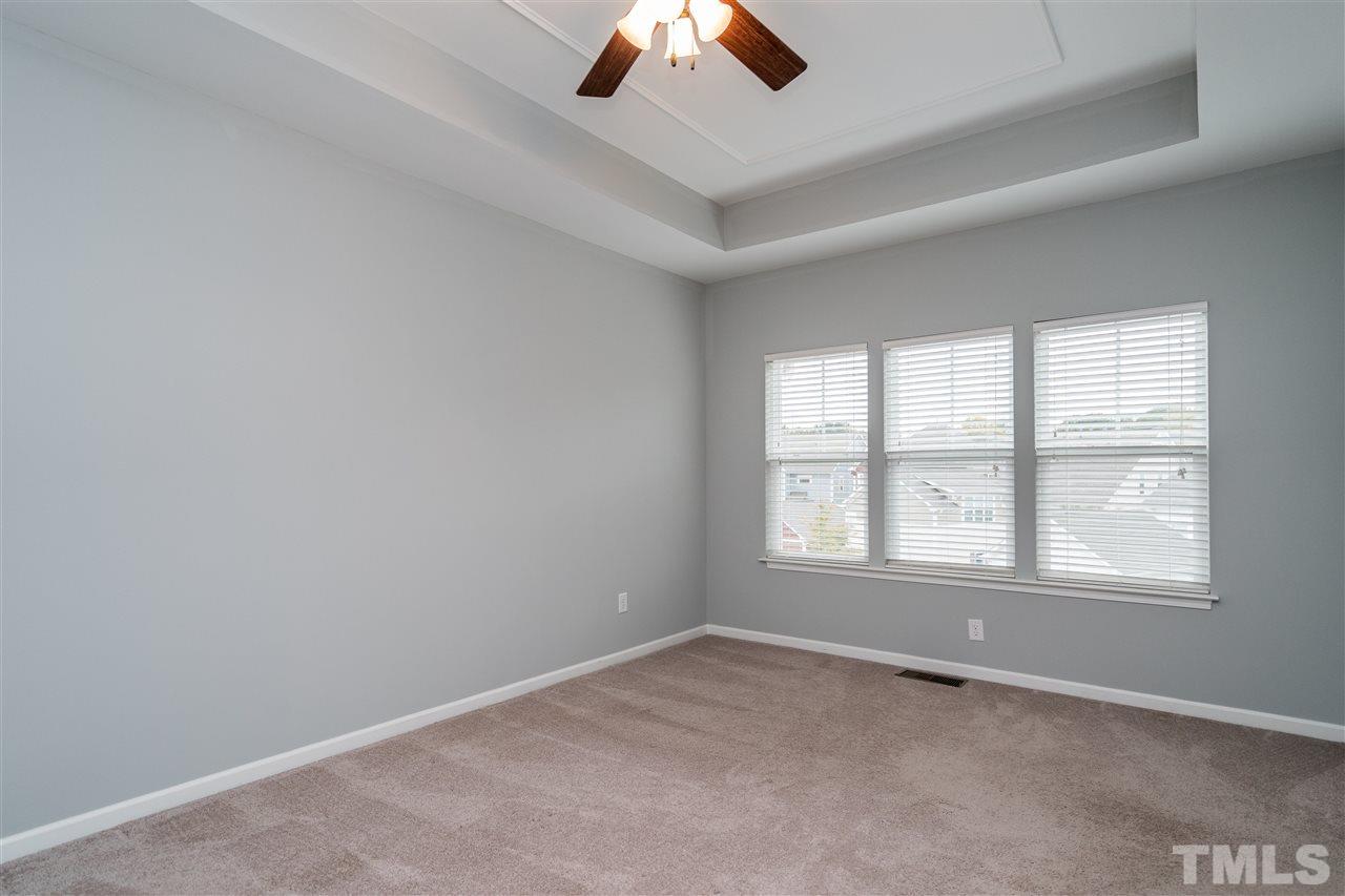 1539 Rodessa Run Raleigh, NC 27607 - Photo 17 of 25 an empty room with a window and a ceiling fan