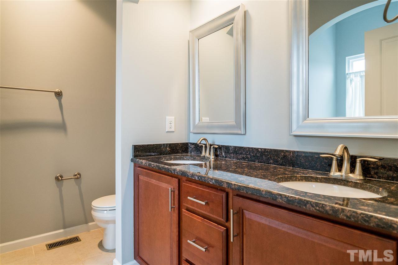 1539 Rodessa Run Raleigh, NC 27607 - Photo 19 of 25 a bathroom with a granite countertop sink a toilet and a mirror