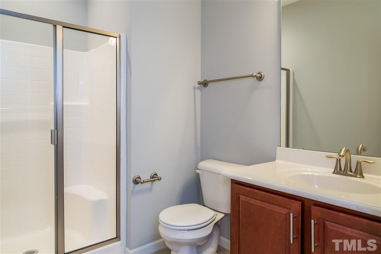 1539 Rodessa Run Raleigh, NC 27607 - Photo 7 of 25 a bathroom with a granite countertop sink toilet and a mirror