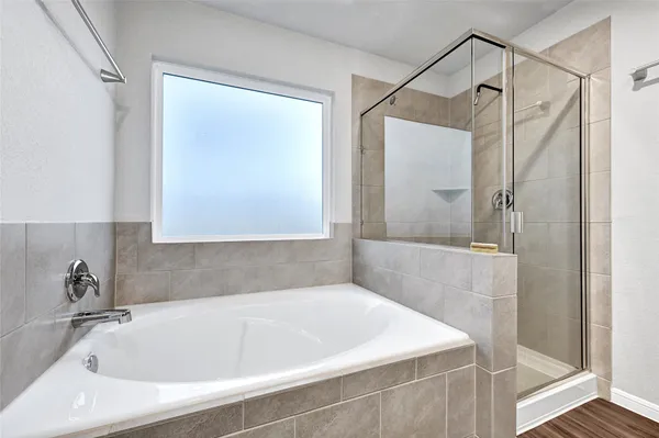 a bathroom with a tub and a shower