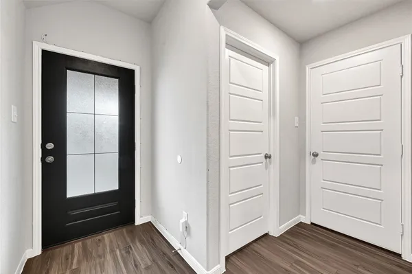 a view of walk in closet with wooden floor