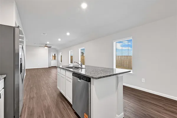 a kitchen with stainless steel appliances granite countertop a stove and a refrigerator