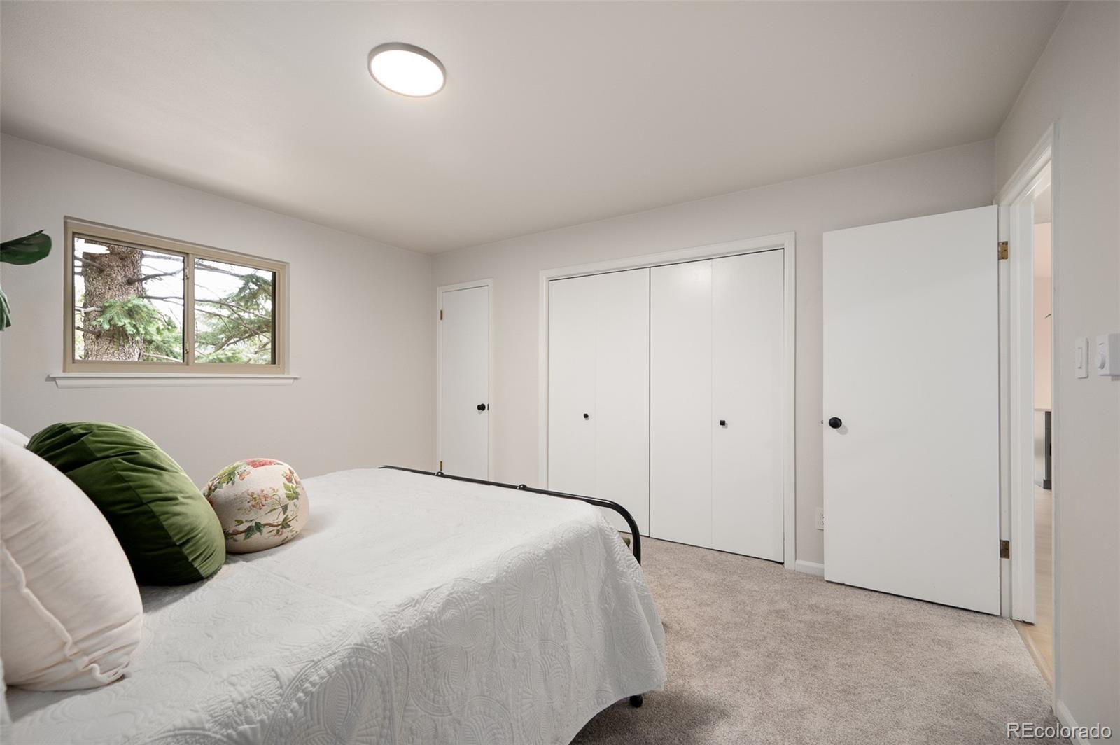 19424 Silver Ranch Road Conifer, CO 80433 - Photo 11 of 43 a bedroom with a bed and a window