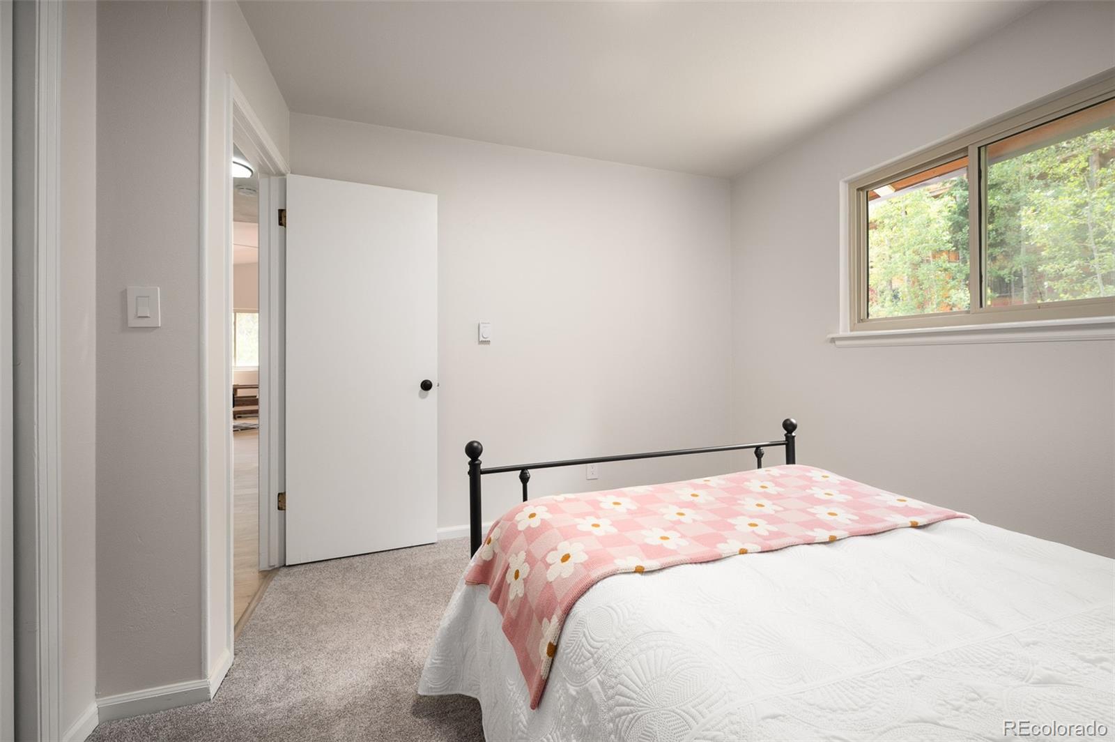 19424 Silver Ranch Road Conifer, CO 80433 - Photo 13 of 43 a bedroom with a bed and a window