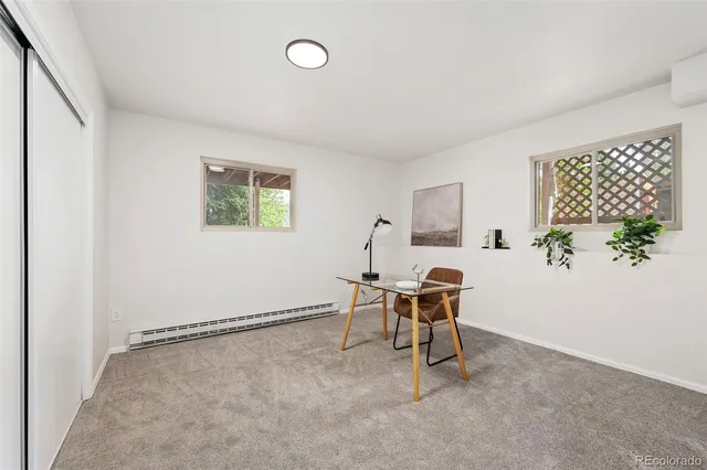 a workspace room with furniture and window