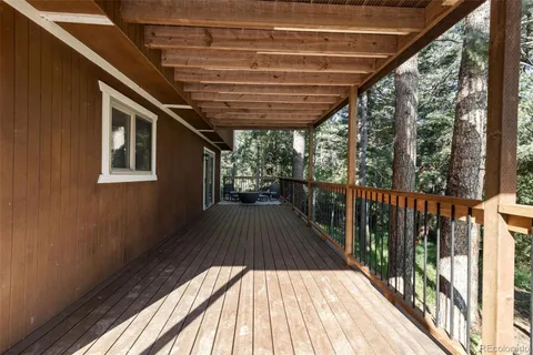 a view of a balcony with couch and wooden floor