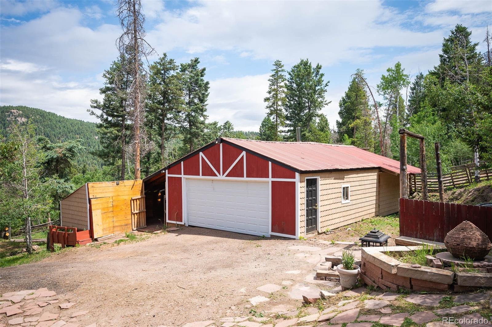 19424 Silver Ranch Road Conifer, CO 80433 - Photo 33 of 43 a front view of a house with a yard