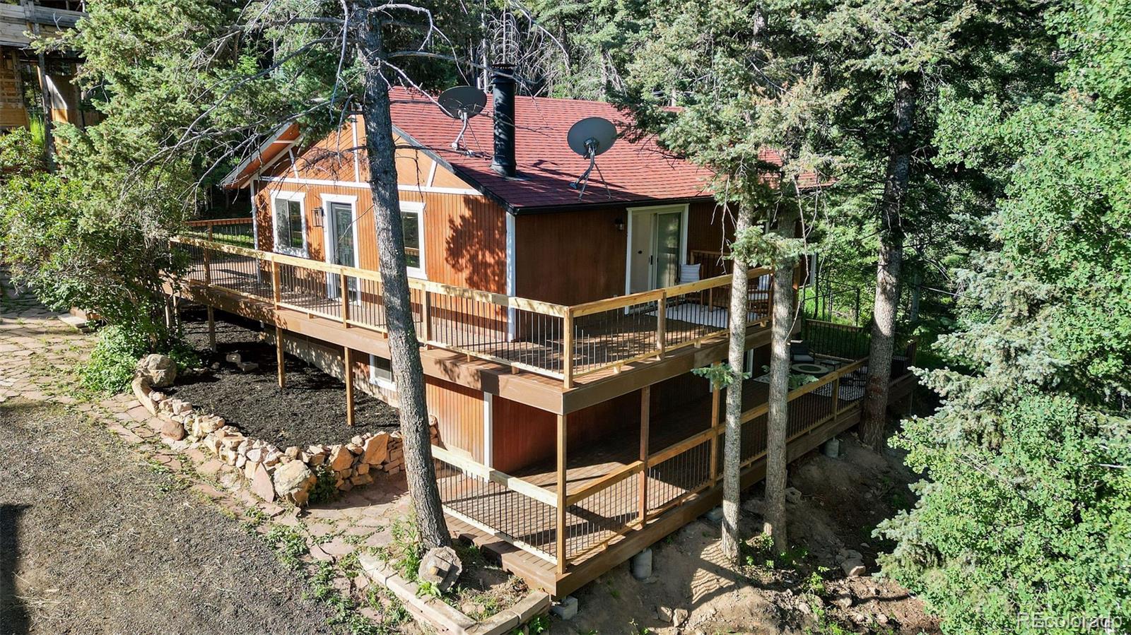 19424 Silver Ranch Road Conifer, CO 80433 - Photo 34 of 43 a front view of a house with parking space