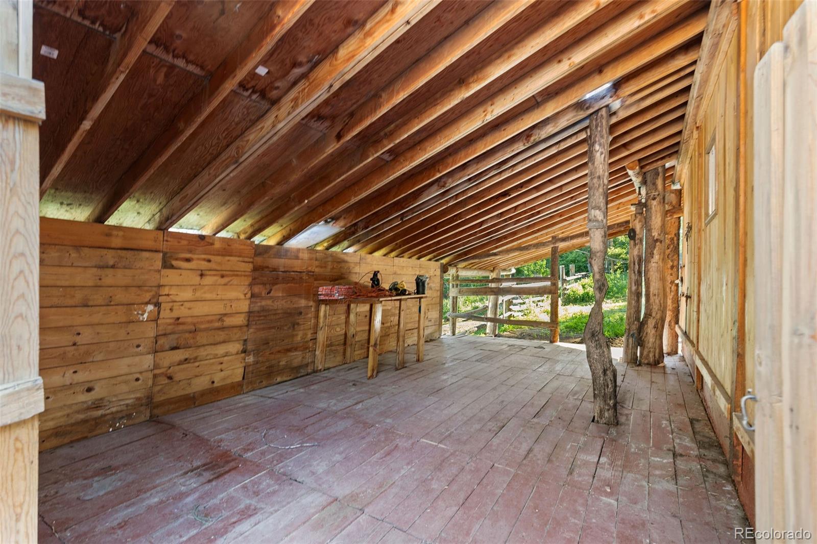 19424 Silver Ranch Road Conifer, CO 80433 - Photo 37 of 43 a view of an empty room with wooden floor