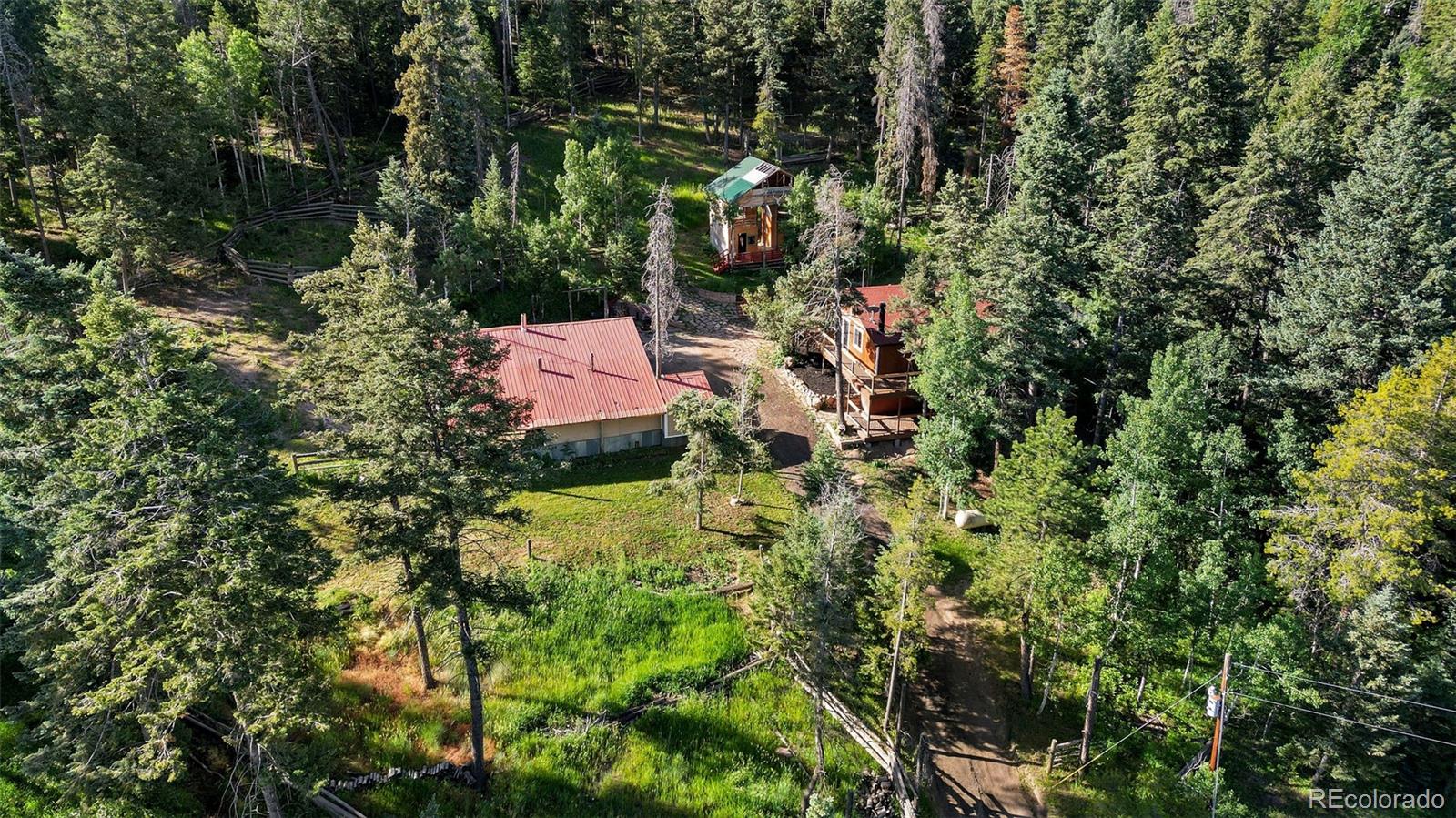 19424 Silver Ranch Road Conifer, CO 80433 - Photo 38 of 43 a backyard of a house with a yard and outdoor seating