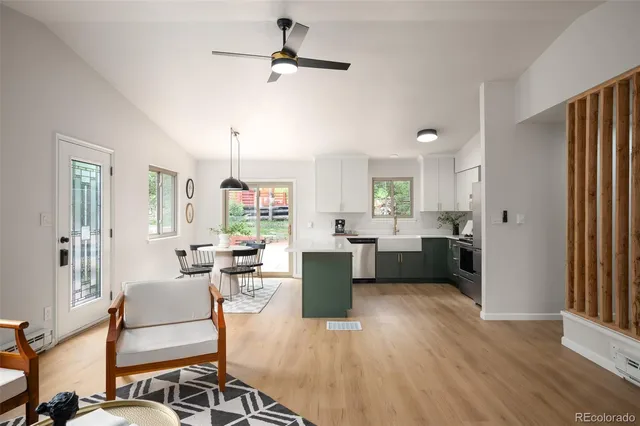 a living room with furniture and a wooden floor
