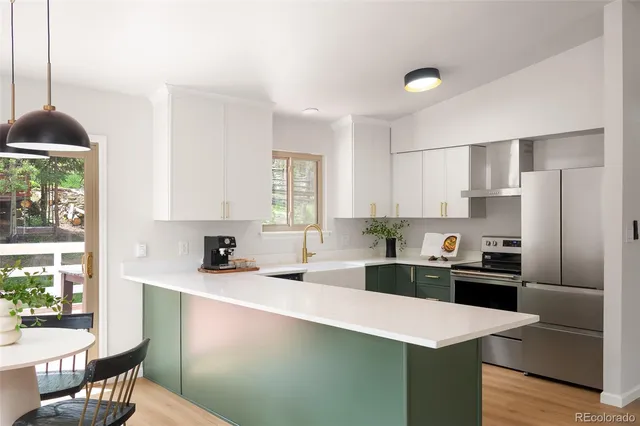 a kitchen with granite countertop a sink stove and refrigerator