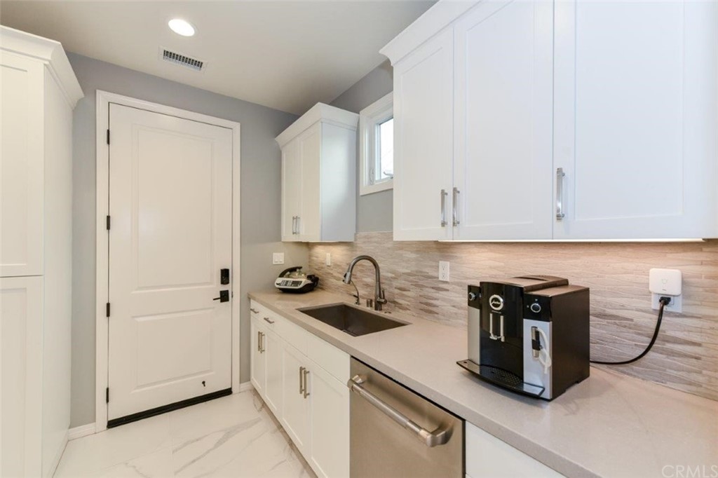 134 Paxton Irvine, CA 92620 - Photo 17 of 51 a kitchen with a sink a stove and cabinets