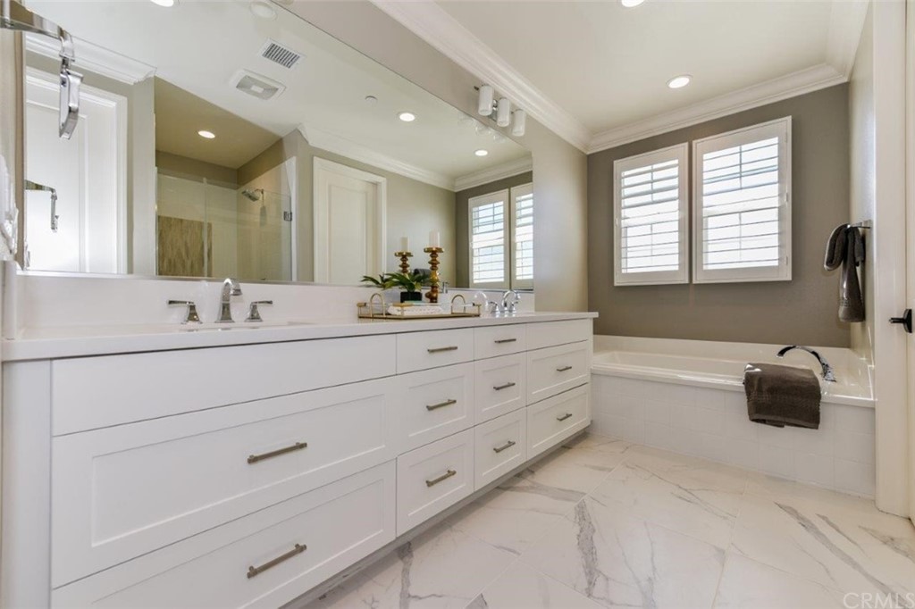 134 Paxton Irvine, CA 92620 - Photo 28 of 51 a bathroom with a double vanity sink mirror and bathtub