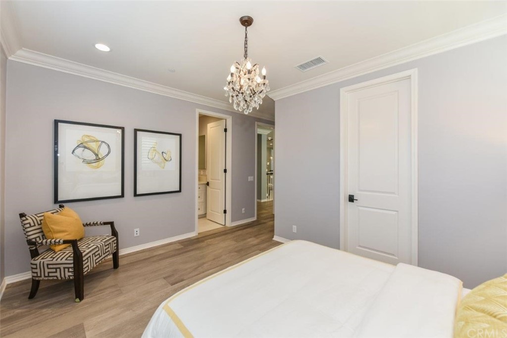 134 Paxton Irvine, CA 92620 - Photo 30 of 51 a bedroom with a bed chandelier and a window