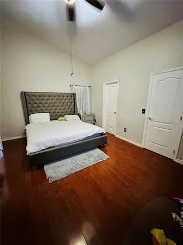 a bedroom with a bed and painting on the wall