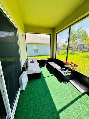 a view of a swimming pool with furniture