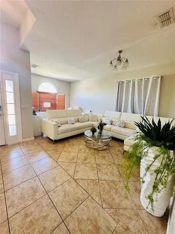 a living room with furniture and a chandelier